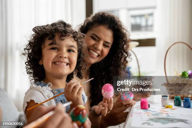 portrait of child painting easter eggs - påskägg bildbanksfoton och bilder