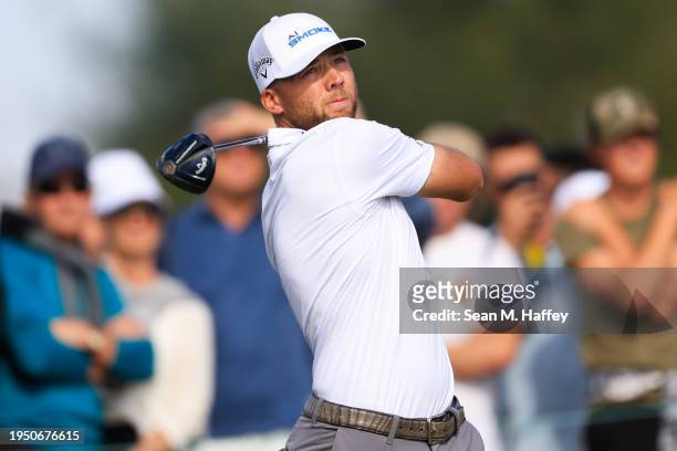 Sam Burns of the United States hits a tee shot on the eighth hole during the final round of The American Express at Pete Dye Stadium Course on...