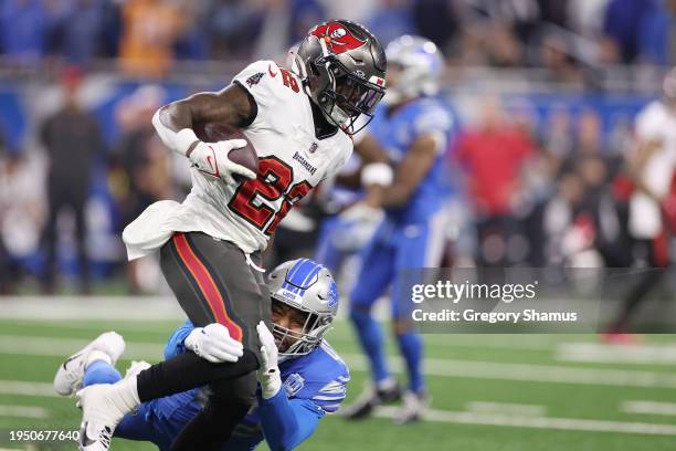 Chase Edmonds of the Tampa Bay Buccaneers is pursued by Jalen Reeves-Maybin of the Detroit Lions during the second quarter of the NFC Divisional...