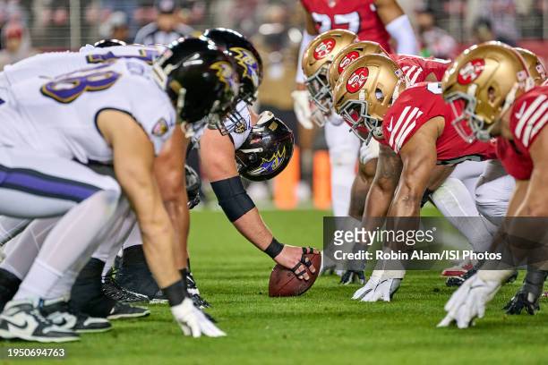 The Baltimore Ravens offensive line is seen with the San Francisco 49ers defensive line at the line of scrimmage in action during a game between the...