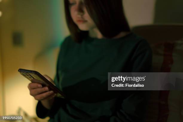 portrait of a person with mobile phone in hand - abuso di minore foto e immagini stock