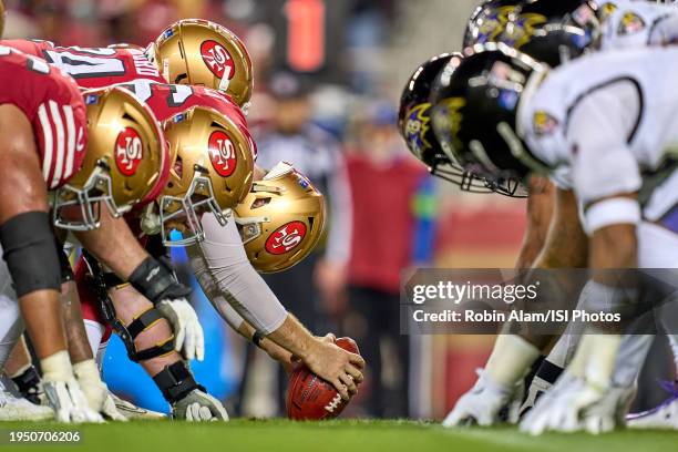 The San Francisco 49ers offensive line is seen with the Baltimore Ravens defensive line at the line of scrimmage in action during a game between the...