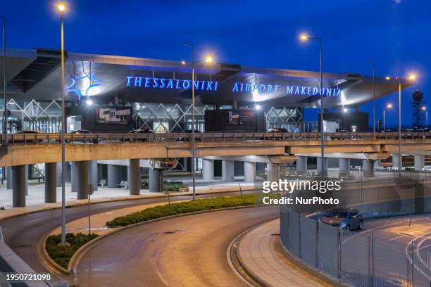 Early morning exterior view during the dawn, magic hour pf the illuminated terminal facilities of Thessaloniki International Airport Makedonia SKG....