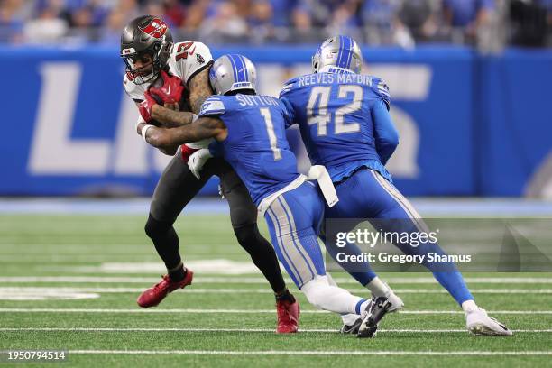 Mike Evans of the Tampa Bay Buccaneers is brought down by Cameron Sutton of the Detroit Lions during the third quarter of the NFC Divisional Playoff...