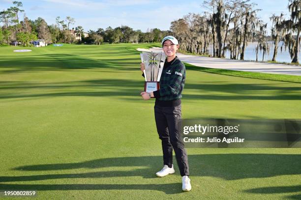 Lydia Ko of New Zealand poses with the trophy after winning the Hilton Grand Vacations Tournament of Champions at Lake Nona Golf & Country Club on...