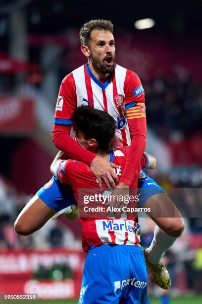 Cristhian Stuani of Girona FC celebrates with his teammate Miguel Gutierrez after scoring their team's fifth goal during the LaLiga EA Sports match...