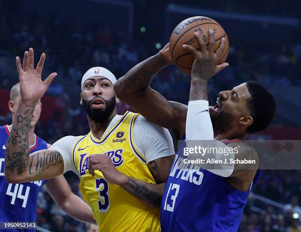 Los Angeles, CA Clippers forward Paul George, #13, right, goes up for a shot as Lakers forward Anthony Davis, #3, defends and Clippers center Mason...
