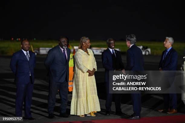 Secretary of State Antony Blinken is welcomed by US Ambassador to Angola Tulinabo Mushingi , Paula Castro , director of the General Directorate of...