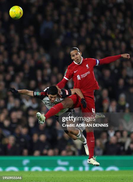 Liverpool's Dutch defender Virgil van Dijk jumps to header the ball above Fulham's Mexican striker Raul Jimenez during the English League Cup...