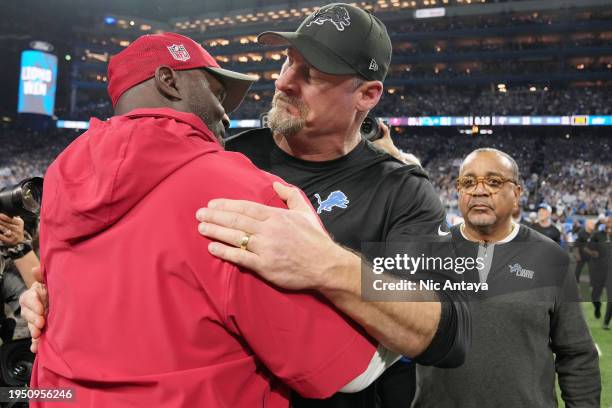 Head coach Todd Bowles of the Tampa Bay Buccaneers speaks with head coach Dan Campbell of the Detroit Lions following the NFC Divisional Playoff game...