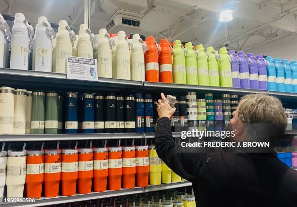 Man shops for Stanley cups and water drinking bottles from a fully-stocked supply at a sporting goods store in Pasadena, California, on January 24,...