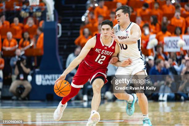 Michael O'Connell of the NC State Wolfpack drives past Taine Murray of the Virginia Cavaliers in the first half during a game at John Paul Jones...