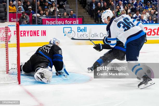 Ilya Samsonov of the Toronto Maple Leafs makes a save against Morgan Barron of the Winnipeg Jets during the second period at Scotiabank Arena on...