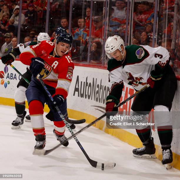 Matthew Tkachuk of the Florida Panthers crosses sticks with Josh Brown of the Arizona Coyotes at the Amerant Bank Arena on January 24, 2024 in...