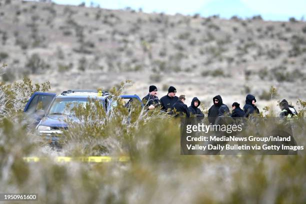 El Mirage, CA Investigators with the San Bernardino County Sheriff's Department investigate a scene where six bodies were discovered on a desolate...