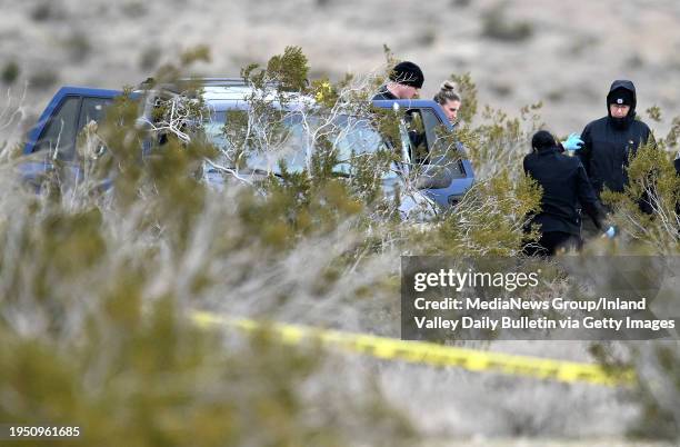 El Mirage, CA Investigators with the San Bernardino County Sheriff's Department investigate a scene where six bodies were discovered on a desolate...
