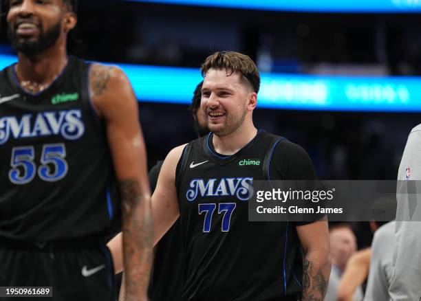Derrick Jones Jr. #55 and Luka Doncic of the Dallas Mavericks smile during the game against the Phoenix Suns on January 24, 2024 at the American...