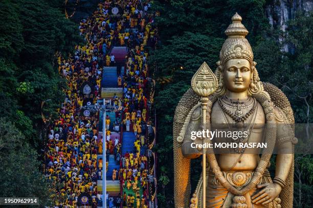 Hindu devotees climb the 272 stairs to the Batu Caves temple to make offerings during the Thaipusam festival at Batu Caves on the outskirts of Kuala...
