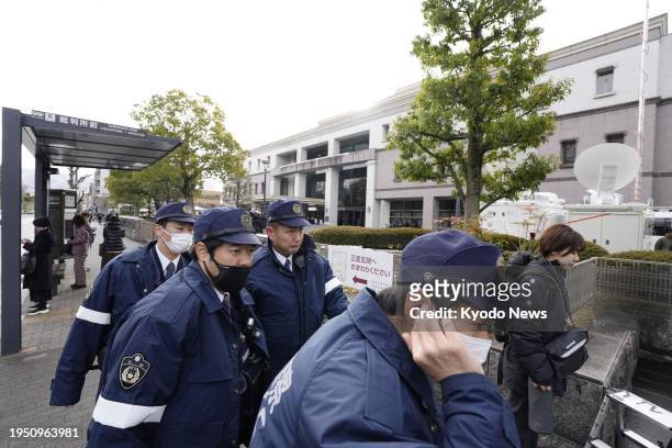 Police officers gather outside the Kyoto District Court in Kyoto, western Japan, on Jan. 25 ahead of the sentencing hearing for Shinji Aoba, who has...