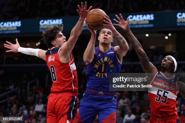 Michael Porter Jr. #1 of the Denver Nuggets shoots in front of Deni Avdija and Delon wright of the Washington Wizards during the first half at...