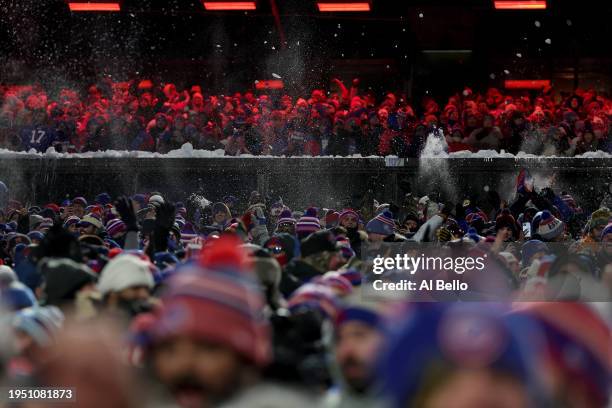Fans celebrate by throwing snow after Josh Allen of the Buffalo Bills scored a touchdown against the Kansas City Chiefs during the second quarter in...
