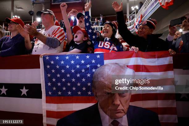 Supporters of Republican presidential candidate and former President Donald Trump cheer during a campaign rally at the Rochester Opera House on...