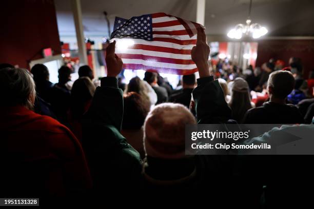 Woman holds up a small U.S. Flag during a campaign rally by Republican presidential candidate and former President Donald Trump at the Rochester...