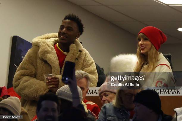 Jerrod Carmichael and singer-songwriter Taylor Swift watch the second quarter in the AFC Divisional Playoff game between the Kansas City Chiefs and...