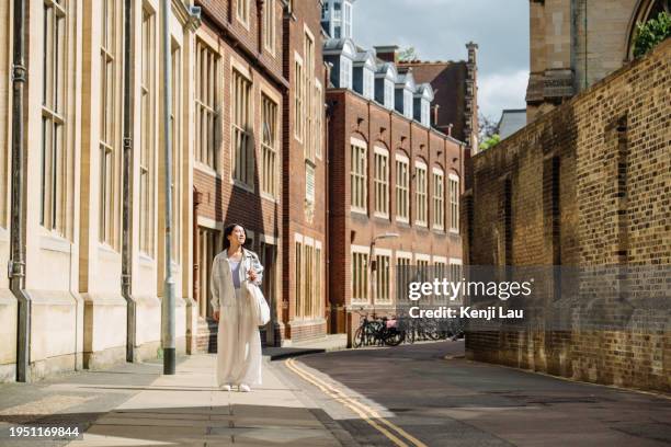 beautiful asian woman exploring the historical town in cambridge on a sunny summer day. travel and holiday. - cambridge stock pictures, royalty-free photos & images