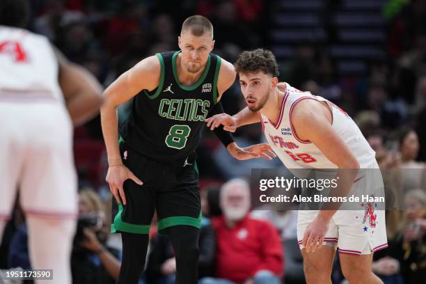 Alperen Sengun of the Houston Rockets and Kristaps Porzingis of the Boston Celtics battle for position during the second quarter of the game at...