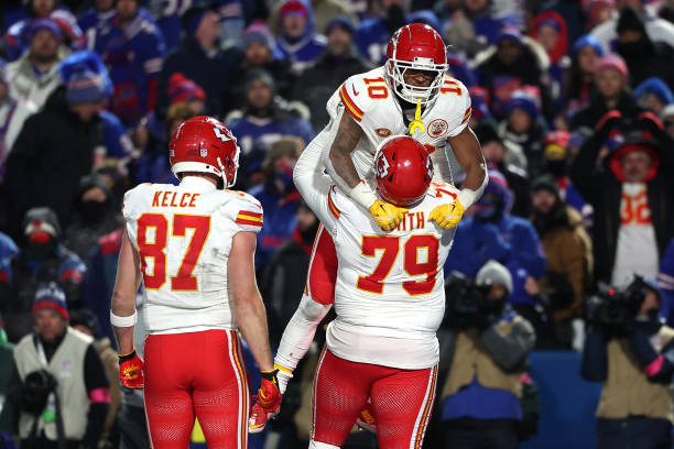 Isiah Pacheco of the Kansas City Chiefs celebrates with Donovan Smith after scoring a touchdown against the Buffalo Bills during the fourth quarter...