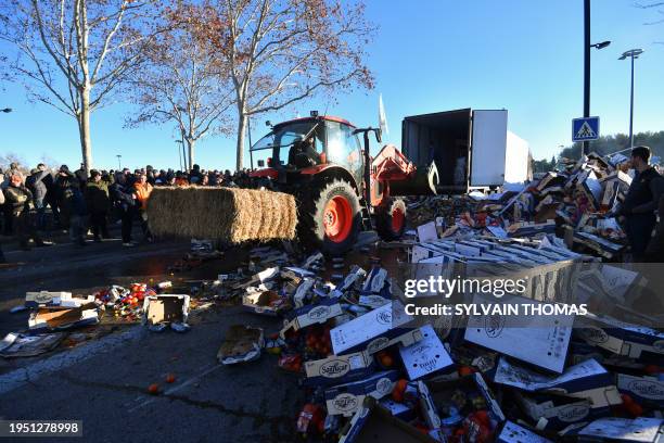 French farmers unloads a Polish truck as they block the A9 highway during a demonstration called by French farmer union FNSEA to protest against a...