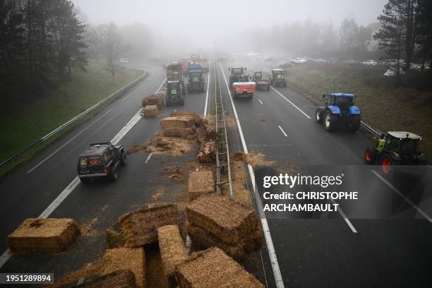 Farmers of the CR47 union block the A62 motor way near Agen, southwerstern France, on January 25 as part of a nation-wide day of actions and road...
