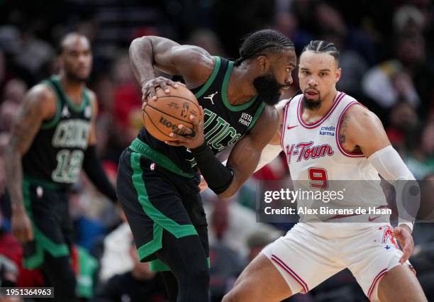 Jaylen Brown of the Boston Celtics holds the ball as Dillon Brooks of the Houston Rockets defends during the third quarter of the game at Toyota...