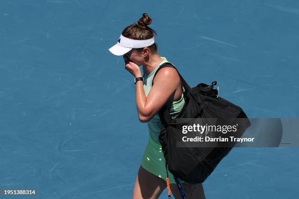 Elina Svitolina of Ukraine walks off court after retiring in their round four singles match against Linda Noskova of Czech Republic during the 2024...