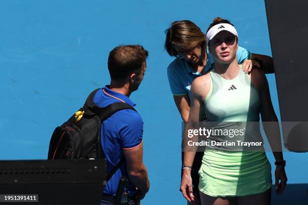 Elina Svitolina of Ukraine receives treatment during a medical time out in their round four singles match against Linda Noskova of Czech Republic...
