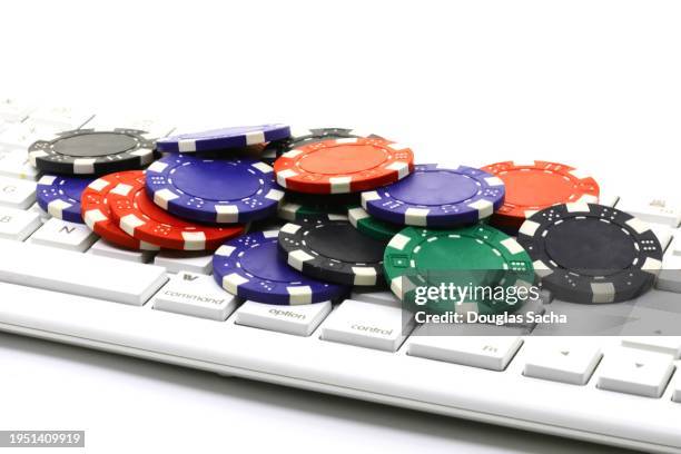 pc keyboard and casino chips - online gambling concept - world series of poker stock pictures, royalty-free photos & images