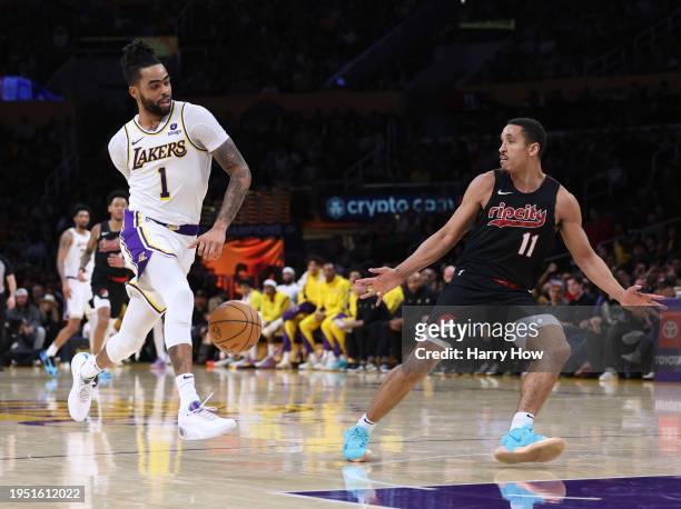 Angelo Russell of the Los Angeles Lakers fakes a pass in front of Malcolm Brogdon of the Portland Trail Blazers to score a layup during a 134-110...
