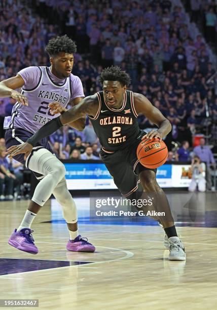 Eric Dailey Jr. #2 of the Oklahoma State Cowboys dribbles the ball past Jerrell Colbert of the Kansas State Wildcats in the first half at Bramlage...