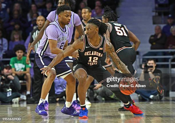 Javon Small of the Oklahoma State Cowboys dribbles the ball against Tylor Perry of the Kansas State Wildcats in the second half at Bramlage Coliseum...