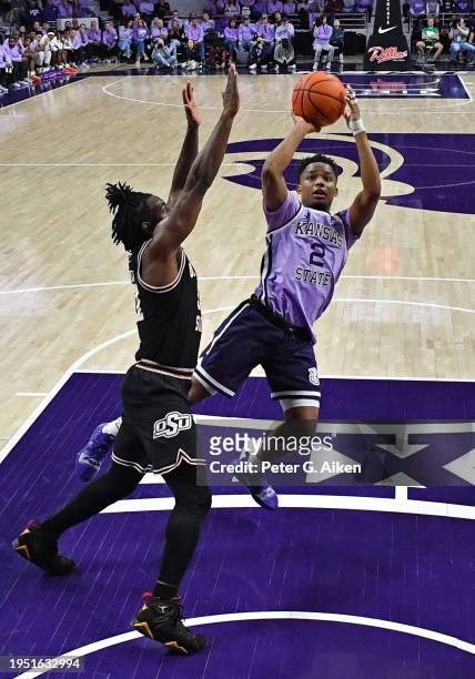 Tylor Perry of the Kansas State Wildcats shoots the ball against John-Michael Wright of the Oklahoma State Cowboys in the first half at Bramlage...