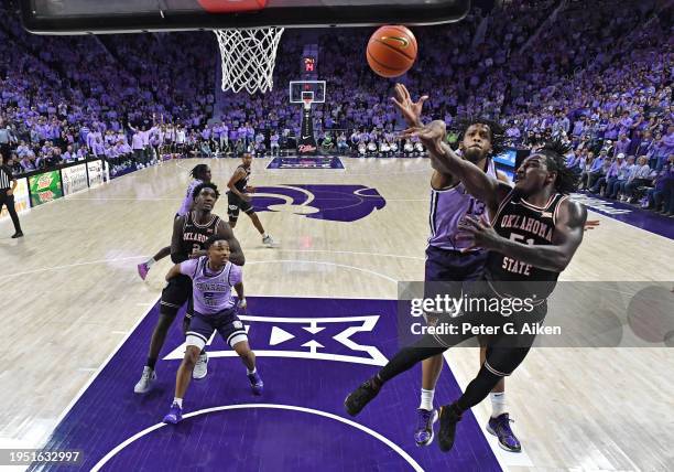 John-Michael Wright of the Oklahoma State Cowboys shoots the ball against Will McNair Jr. #13 of the Kansas State Wildcats in the second half at...
