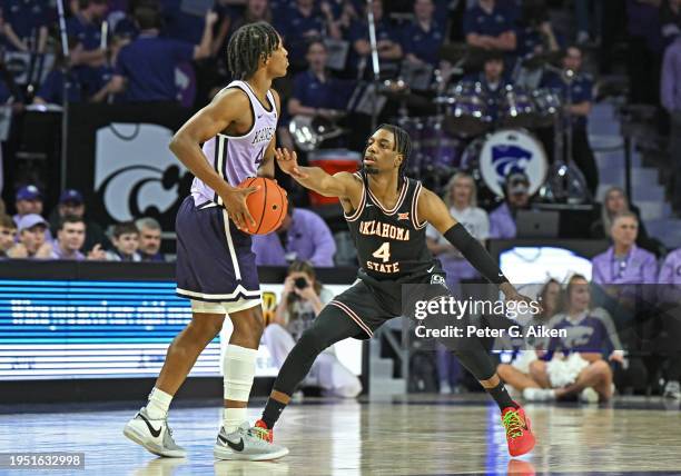 Jarius Hicklen of the Oklahoma State Cowboys defends Dai Dai Ames of the Kansas State Wildcats in the first half at Bramlage Coliseum on January 20,...