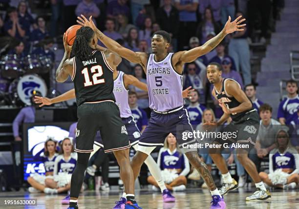 Cam Carter of the Kansas State Wildcats defends Javon Small of the Oklahoma State Cowboys second half at Bramlage Coliseum on January 20, 2024 in...