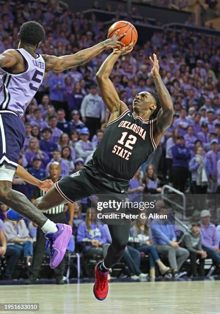 Javon Small of the Oklahoma State Cowboys puts up a shot against Cam Carter of the Kansas State Wildcats in the first half at Bramlage Coliseum on...