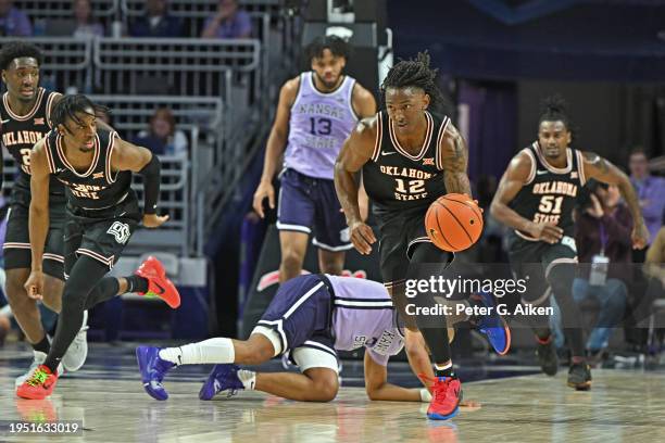 Javon Small of the Oklahoma State Cowboys dribbles the ball down court against the Kansas State Wildcats in the first half at Bramlage Coliseum on...