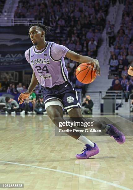 Arthur Kaluma of the Kansas State Wildcats dribbles the ball down court in the second half against the Oklahoma State Cowboys at Bramlage Coliseum on...