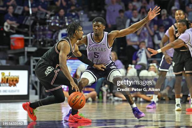 Cam Carter of the Kansas State Wildcats defends Jarius Hicklen of the Oklahoma State Cowboys second half at Bramlage Coliseum on January 20, 2024 in...