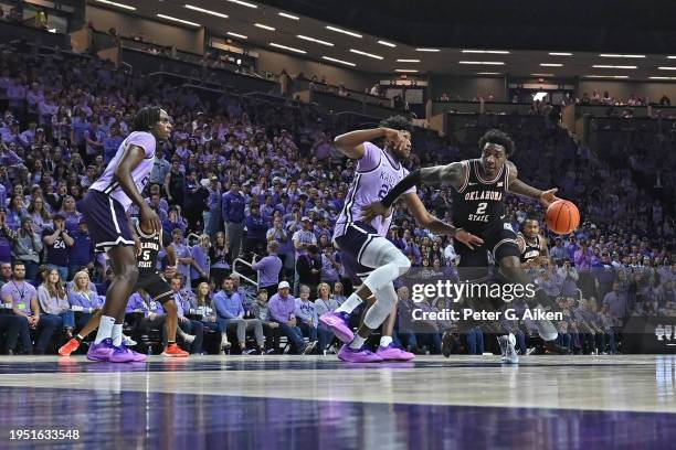 Eric Dailey Jr. #2 of the Oklahoma State Cowboys dribbles the ball past Jerrell Colbert of the Kansas State Wildcats in the first half at Bramlage...