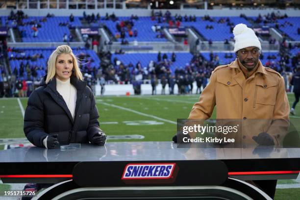 Reporter Michelle Beisner-Buck and analyst Robert Griffin III cover the pregame show at the AFC Divisional Playoff game at M&T Bank Stadium on...
